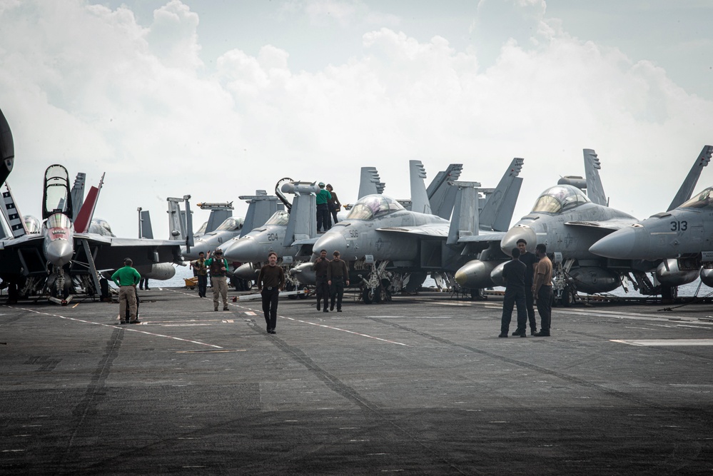 U.S. Navy sailors working on an aircraft carrier flight deck